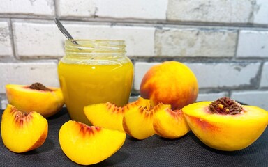 Glass jar of fresh delicious homemade jam made from ripe juicy peaches. The concept of proper nutrition, agriculture.