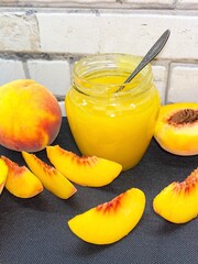 Glass jar of fresh delicious homemade jam made from ripe juicy peaches. The concept of proper nutrition, agriculture.