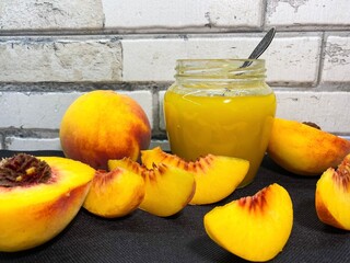Glass jar of fresh delicious homemade jam made from ripe juicy peaches. The concept of proper nutrition, agriculture.