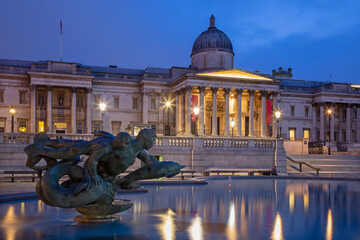 London - The fountain and Trafalgar square at dusk.