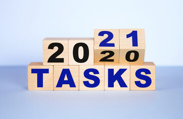 Business concept of planning 2021. Wooden cubes with the inscription tasks 2020-2021.