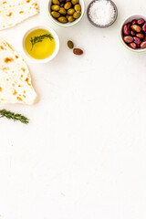 Fototapeta na wymiar Italian olives, oil, bread - appetizer and snacks - top view copy space