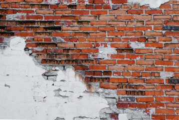 Grunge brick wall with crumbling plaster, brick texture, abstract background