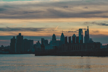 Fototapeta na wymiar A View of the Philadelphia Skyline Over Water on a Dramatic Sunset