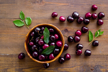 Berries in the bowl. Red cherry top view, copy space