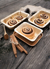 Cinnamon rolls on a plate from nature on a wooden table.