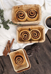 Cinnamon rolls on a plate from nature on a wooden table.