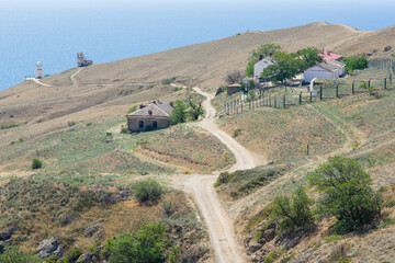 View of the lighthouse at cape Meganom and the lighthouse keeper's hut. Crimea.