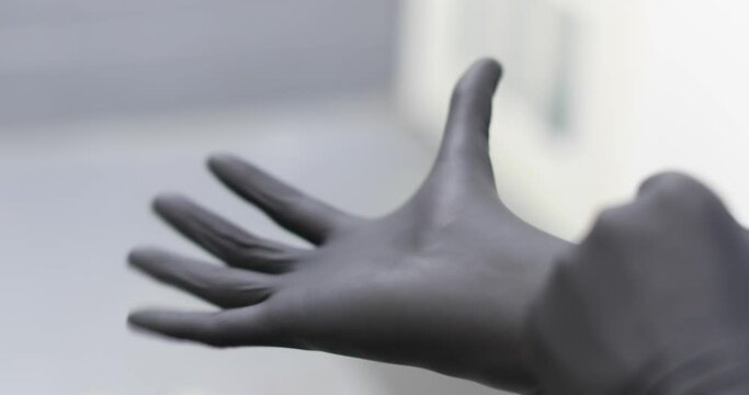 putting on a latex glove
