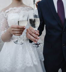 bride's hand with an elegant wedding ring with white gold diamonds on a bouquet