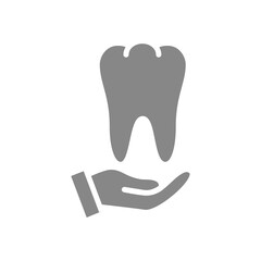 Human tooth on hand gray icon. Disease prevention symbol