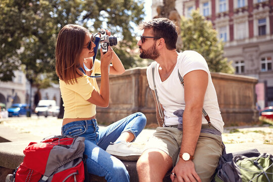 Young tourist couple taking photo at the city landmarks