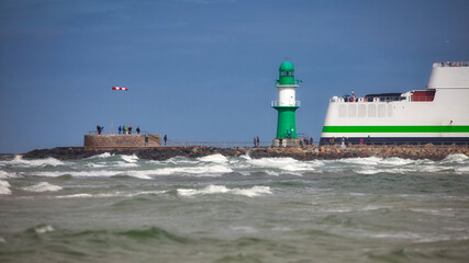 warnemuende pier light on stormy wheather with windbag