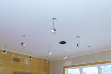 Close-up hand changes a light LED in a stylish preparations for ceiling lamp interior lighting...
