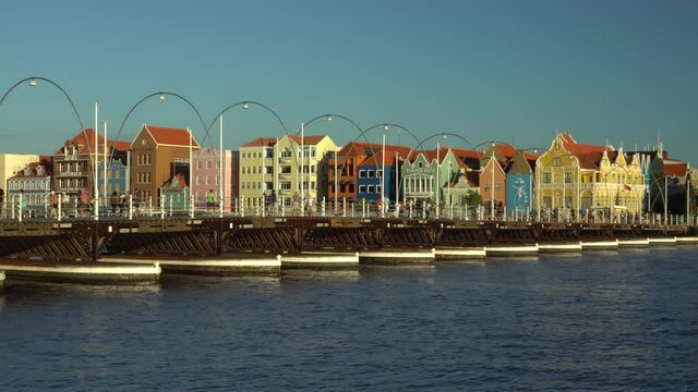 Willemstad, Curacao / Dutch Antilles -  November 18th 2019: Floating bridge  Queen Emma with colorful buildings of Punda in the background