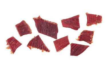 Pieces of beef jerky isolated on white background, top view. Cured meat. Dried meat.