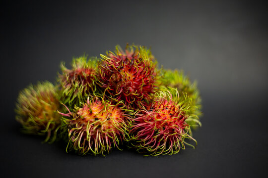 Imperfect rambutans can coexist with perfect rambutans. fruit on black background