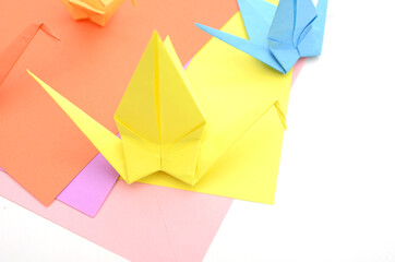 Colorful origami paper birds with blank sheets
