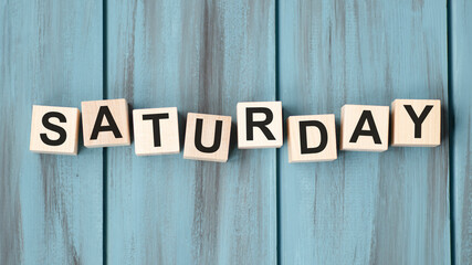 The word Saturday on wooden cubes. Weekday concept.