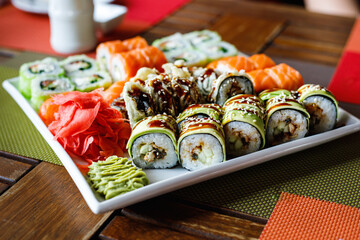 Sushi set of different types on a plate. Sushi in the sushi bar. Selective focus.