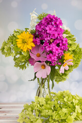 Bright bouquet of flowers on a beautiful background. green hydrangea and Phlox in a designer bouquet.