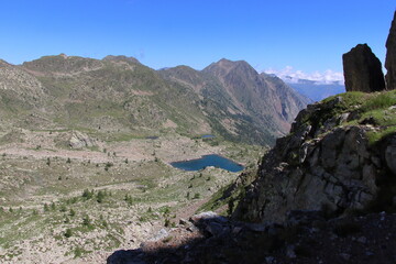 Fototapeta na wymiar Jaw-droppingly beautiful mountains and lakes in Sant'Anna di Vinadio on a partly cloudy day.