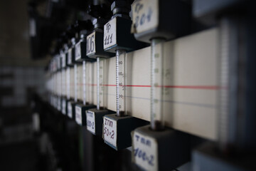 Close-up of rotameters in a dark technical room. Rotameters in the cable hub.