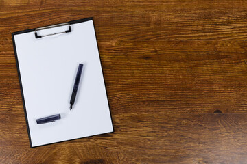 View of a notebook and pen on wood table background