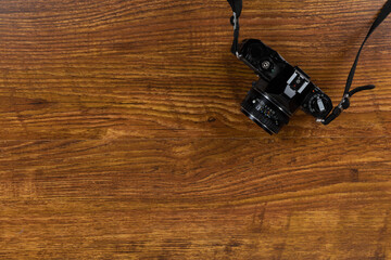 View of a camera on wood table background
