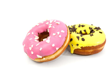 two delicious donuts with yellow and pink frosting isolated on a white background. Close-up.