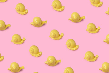 Pattern made from yellow snails on the pink background. Modern pop art concept. Flat lay.