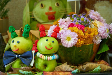 autumn children's creativity,children's art for the autumn holiday, caterpillar apples and flowers in a pumpkin