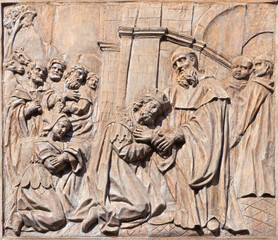 CATANIA, ITALY - APRIL 7, 2018: The baroque carved relief from live of St. Benedict (with the Totila king of Ostrogoths) on the gate of church Chiesa di San Benedetto.