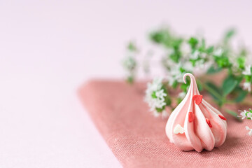 Close-up small pink meringues on a pink background. Handmade. Celebration.