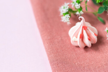 Close-up small pink meringues on a pink background. Handmade. Celebration.