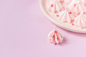 Close-up small pink meringues on a pink background. Handmade. Celebration.