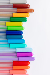 multi-colored markers on a white background