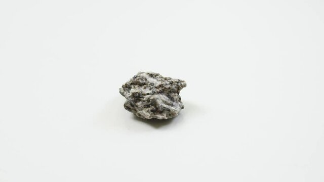 detail of white mica schist over white background