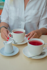 woman holding cup of tea