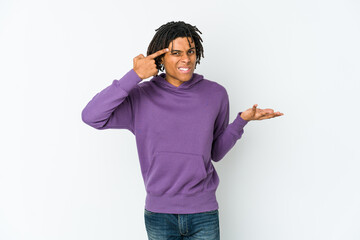 Young african american rasta man showing a disappointment gesture with forefinger.
