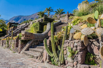 Staircase in a garden with the replica of the plumed (feathered) serpent on a splendid and sunny day in Chapala, Jalisco Mexico