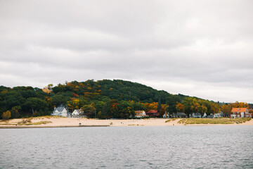 Fall landscape of the lake beach with walking people  in Michigan