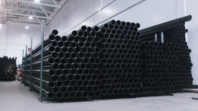 Narrow black plastic tubes in the manufacturing warehouse