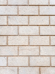 Brickwork of light spotted decorative bricks. Full screen photo. Background texture