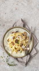 Pasta fettuccine with mushrooms, creamy sauce and parmigiano cheese