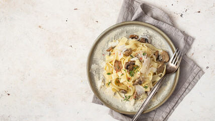 Pasta fettuccine with mushrooms, creamy sauce and parmigiano cheese