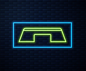 Glowing neon line Step platform icon isolated on brick wall background. Vector.