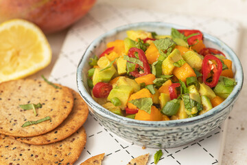 Fresh salad with mango, red pepper, avocado and mint