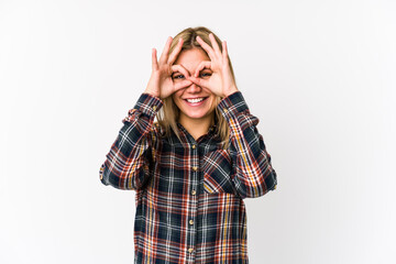 Young blonde caucasian woman isolated showing okay sign over eyes