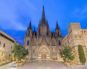 Fototapeta na wymiar Barcelona - The facade of old gothic cathedral of the Holy Cross and Saint Eulalia at dusk.